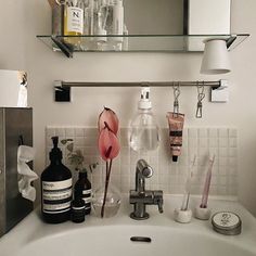 a bathroom sink that has some bottles on it