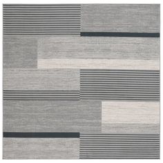 a gray rug with black and white stripes on it