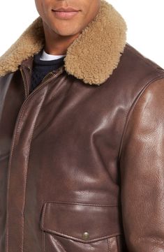 A detachable shearling collar tops a tough, wax-finished cowhide bomber jacket constructed with bi-swing back panels for enhanced movement. Not only is the jacket's washed grained leather rugged in appearance, but its long-lasting American-made construction lets the leather age beautifully and naturally over time. Cozy quilting lines the style for warmth 28" length (size Medium) Front zip closure Ribbed cuffs and hem Front snap-flap pockets; interior snap-welt pocket Fully lined Leather with gen Leather Jacket With Contrast Collar For Winter, Classic Fitted Leather Jacket With Faux Fur Lining, Classic Sheepskin Leather Jacket For Work, Luxury Collared Leather Jacket For Winter, Classic Leather Outerwear With Faux Fur Trim, Aviator Leather Jacket With Padded Collar For Fall, Classic Fitted Shearling Leather Jacket, Classic Brown Leather Jacket With Padded Collar, Classic Leather Jacket With Faux Fur Trim