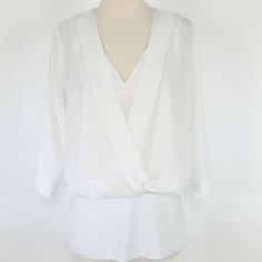 Cabi | White Indulge Top 3/4 Sleeve (Size: Xl) -Blouse -3/4 Sleeve -V Neck -Faux Wrap -Back: Zipper Closure -Material: Top 100% Polyester Bottom Piece: 67% Rayon, 28% Nylon, 5% Spandex -Color: White -Size: X-Large -Pit To Pit: 27" -Waist: 19" -Sleeves: 19" -Nwot: New Without Tags White 3/4 Sleeve Tops For Layering, White 3/4 Sleeve Blouse For Work, Spring Blouse With 3/4 Sleeves For Layering, Formal Summer Tops With 3/4 Sleeves, Elegant Top With 3/4 Sleeves For Daywear, Elegant 3/4 Sleeve Blouse For Brunch, Elegant 3/4 Sleeve Tops For Brunch, Elegant Half Sleeve Tops For Brunch, Spring Floral Blouse