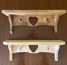 two wooden shelfs with hearts cut out of them