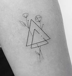 a black and white photo of a triangle tattoo on the right side of the thigh