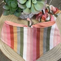 a hat that has succulents in it on top of a wooden table