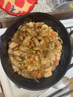 a skillet filled with food sitting on top of a stove next to an oven