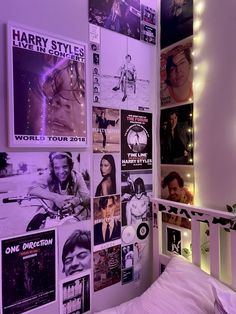 a bedroom with posters and lights on the wall