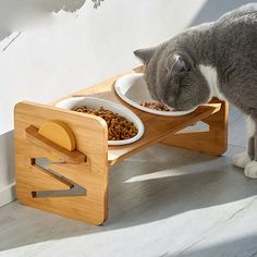 a cat eating out of a wooden elevated feeding station