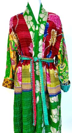 Kantha Kimono Coat Will Exceed Your Expectations. Each coat is engineered with fashion in mind. Tailored as a trench coat, intended to be worn as an outerwear piece. Stunning example of kantha stitching, mixed print, exhibiting refined craftsmanship. Soft, Colorful, and Easy. One of a kind. Designer details throughout. This statement piece is crafted from ultra lux kantha stitch vintage cotton sari. Features long sleeves, two deep interior pockets with a wide self tie matching belt. Absolutely a Fitted Multicolor Long Outerwear, Spring Outerwear With Patchwork And Kimono Sleeves, Red Long Patchwork Outerwear, Long Red Patchwork Outerwear, Long Multicolor Spring Outerwear, Multicolor Long Coat With Patchwork, Multicolor Patchwork Outerwear With Kimono Sleeves, Fitted Outerwear With Kimono Sleeves For Fall, Spring Long Coat Outerwear With Patchwork