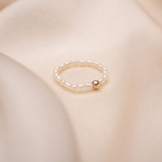 Gear up for summer with our newest addition to the family. Our Fresh Water Pearl Ring with a 14k Solid Gold Bead is a must have to your collection. It's small and dainty, yet creates a timeless look. Available in sizes 4-9 Material: 14k Solid Gold Ball, Fresh Water Pearls all beaded on a durable elastic string. Simple Pearl Ring, Pearl Ring Simple, Fresh Water Pearl Ring, Ring Pearl, Simple Pearl, Freshwater Pearl Ring, Fresh Water Pearls, Fresh Water Pearl, Water Pearls