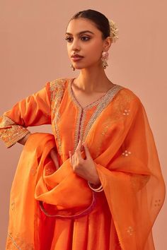 Tangerine orange peplum anarkali with tilla, patra, zari thread embroidery. Paired with gharara and geometric hand block print dupatta.
Components: 3
Pattern: Embroidery
Type Of Work: Tilla, patra, zari thread
Neckline: V neck
Sleeve Type: Three quarter
Fabric: Kurta: Silk Chanderi, Gharara: Georgette, Dupatta: Silk Organza
Color: Orange
Other Details: 
Tiered gharara
Gota lace embroidered hem
Sheer printed dupatta
Occasion: Sangeet - Aza Fashions Georgette Garara, Lucknowi Kurta, Blue Block Heels, Chikankari Lehenga, Half Jacket, Bridal Lehenga Red, Green Lehenga, Tangerine Orange, Sharara Set