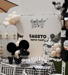 a mickey mouse themed birthday party with black and white balloons