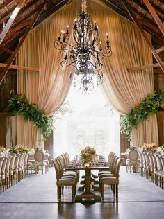 an elegant dining room with chandelier and chairs