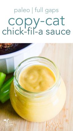 a close up of a jar of food on a wooden table with celery