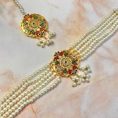 Nauratan/Navratan Pearl Choker and Tikka Bridal Set. Gorgeous intricate details. Gold Plated Multicolored design.  ✔️Adjustable Choker Necklace ✔️100% handmade ✔️Rare find! ✔️Comes in a gorgeous packaged gift box ✔️Pearl strings and details, along with a pearl chain for the tikka Elegant Multicolor Tikka For Festive Occasions, Elegant Multicolor Tikka For Diwali, Elegant Multicolor Festive Tikka, Elegant Multicolor Traditional Wear For Celebration, Elegant Multicolor Tikka For Festivals, Gold Pearl Choker, Pearl Strings, Pearl Choker, Pearl Chain