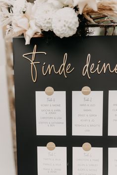 a black and white wedding seating chart with gold foil lettering that says, find deine