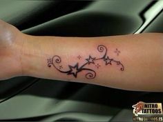 an arm with stars and swirls on it