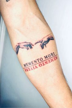 a man with a tattoo on his arm that says, mementoo mori