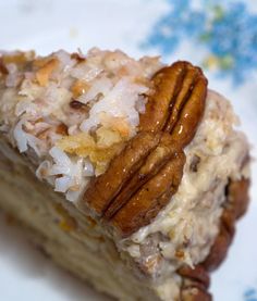 a piece of cake with pecans and coconut on top