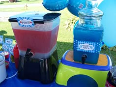 an ice cream maker sitting on top of a table next to balloons and water bottles