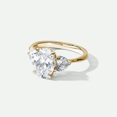 an oval diamond ring with three pear shaped diamonds