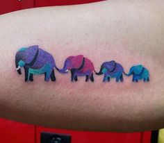 an arm with three elephants on it and the word love is written in different colors