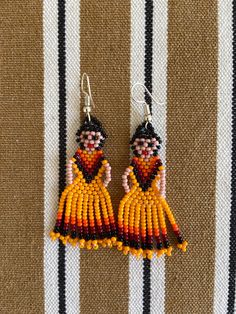 Huichol earrings These handmade beaded earrings are so colorful and lightweight. They are unique and made by the huichol artisans Huichol art and handcrafts are popular worldwide because of the beauty of the jewelry they make and all the art and tradition that the community represents 100% handmade Please notice that due all the light effects, color may vary slightly All orders are shipped using Mexican Postal Service and it takes: 15-25 bussines days (North America). 20-30 bussines days (Europe Doll Earrings, Huichol Earrings, Beautiful Beaded Earring, Mexican Doll, Handmade Beaded Earrings, Mexican Earrings, Beaded Necklace Patterns, Huichol Art, Beaded Necklace Diy