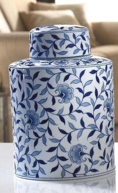 a blue and white vase sitting on top of a table