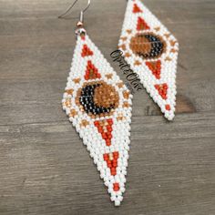 the beaded earrings are designed to look like a dog on a slice of pizza