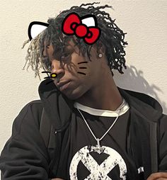 a man with dreadlocks wearing a black hoodie and a red bow tie