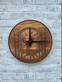 a wooden clock with an image of a deer in the woods