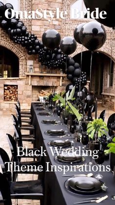 black wedding theme with balloons and greenery on the table in front of an old brick building