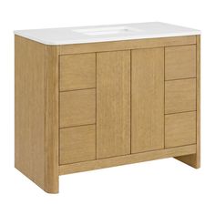 a bathroom vanity with a white counter top and wooden cabinet doors on both sides,