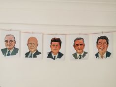 five portraits of men hanging on a line in front of a white wall with red string