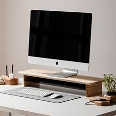 an apple computer sitting on top of a white desk