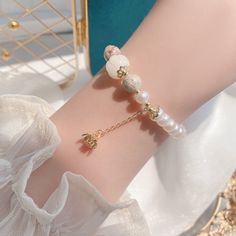 Add a touch of luxury to your look with this beautifully crafted bracelet. Designed to withstand the test of time and elevate any look. Freshwater pearl, agate Bead diameter: 6 mm 10K gold Elastic - Suitable for hand circumference: 14-18 CM Hypoallergenic, lead & nickel free *We carefully select each gemstone to offer gems with the best quality. As gemstones are natural materials, stone colors may vary slightly from the images, making this beautiful bracelet completely unique, just like you!If you aren't in LOVE with your purchase, please let us know within 30 days of receiving your item, and you'll receive a stress-free refund. Elegant Natural Stones Beaded Bracelet, Natural Stones Pearl Bracelet As A Gift, Elegant Agate Crystal Bracelet With Gemstone Beads, Pearl White Bangle Bracelet Gift, Pearl White Bangle Bracelet For Gift, Pearl White Bangle Bracelets For Gifts, Elegant Pearl Bracelet With Natural Stones For Gift, Elegant Natural Stone Beaded Bracelets For Gift, Elegant Beaded Bracelets With Natural Stones For Gift