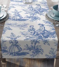 a blue and white table cloth on top of a wooden table