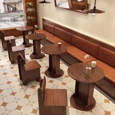 an empty restaurant with wooden tables and chairs