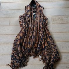 Gorgeous Cozy Blanket Draped Lapel Open Front Vest From Anthropologie Made By Plenty By Tracy Reece. Beautiful Color Palette Of Tan, Brown And Deep Navy Blue In An Aztec Triangle Pattern With Leather Trim And Fun Fringe Hem. New With Tags. Size Xs/Small. #Aztec #Navajo #Yellowstone #Blanket #Vest #Fleece Bohemian Brown Outerwear For Layering, Bohemian Brown Vest For Fall, Brown Bohemian Winter Vest, Bohemian Vest For Fall Layering, Bohemian Brown Winter Vest, Winter Bohemian Brown Vest, White Faux Fur Vest, Open Front Vest, Trench Vest