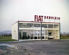 an old photo of a car dealership with the word fiat on it's front