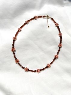 adorn yourself with the rich, chocolatey hues of the cocoa blossom necklace 🤎 ❥ bead assortment: mini brown glass crystals & acrylic flower beads  ❥ length: 16, 18 or 20 inches + extension chain with heart tag ❥ necklace findings: gold or silver plated stainless steel & tarnish resistant ⊹ ₊  ₊ ⊹⊹ ₊  ₊ ⊹⊹ ₊   ʚ♡⃛ɞ jewelry care tips ʚ♡⃛ɞ ❥ don't leave your beaded jewelry sitting in the sun ❥ avoid excessive stretching or pulling on your necklace ა heavenly made in NC ໒꒱ Brown Flower-shaped Beaded Jewelry, Brown Beaded Necklace With Faceted Beads For Gifts, Brown Faceted Beads Necklace As Gift, Brown Faceted Beads Necklace For Gift, Accessories Minimalist, Brown Necklace, Boho Choker, Acrylic Flowers, Fall Accessories