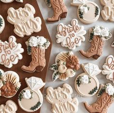 cookies decorated with cowboy boots and flowers on a table