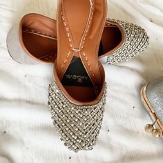 Immerse yourself in the allure of our Pearly Blinders pearl bridal shoes, showcasing a luminous bright grey base reminiscent of a serene winter sky. Adorned with sparkling rhinestones and elegant imitation pearls, these most comfortable bridal shoes are a perfect blend of timeless tradition and contemporary charm. Each pair of jeweled wedding flats is meticulously handcrafted to ensure both beauty and comfort, making them an exquisite choice of sparkly wedding flats for any special occasion. Pro Comfortable Wedding Flats, Flats For Bride, Bridal Shoes Comfortable, Wedding Flats For Bride, Formal Flats, Comfortable Bridal Shoes, Fabric Embellishment, Sparkly Wedding, Winter Sky