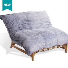 a small futon sofa bed with a wooden frame and foot rest in grey color