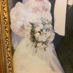 an old photo of a bride and groom posing for a wedding photograph in front of a gold frame