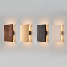 four different types of wall lights mounted on the side of a wall in a room