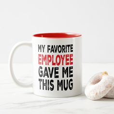 a coffee mug that says, my favorite employee gave me this mug with two donuts