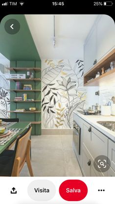 the kitchen is decorated in green and white with an artistic wall mural behind the sink