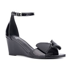 Textured bow details add a feminine twist to the shelby sandal, featuring a wedge heel. With a polished buckle closure on the ankle strap, it pairs perfectly with a sleek sheath dress. Closure Type: BuckleShoe Heel Height: 3 InchesUpper/Outer Base Material: 100% LeatherShoe Lining Material: LeatherSole Material Content: 100% RubberToe Type: Open Toe, Pointed ToeShoe Strap Type: Ankle StrapHeel Style: Wedge HeelCountry of Origin: Imported Spring Patent Leather Wedge Sandals, Spring Wedge Heel Patent Leather Sandals, Chic Patent Leather Wedge Sandals For Summer, Summer Formal Patent Leather Wedge Sandals, Formal Summer Patent Leather Wedge Sandals, Spring Formal Patent Leather Wedge Sandals, Patent Leather Wedge Sandals For Spring Evening, Patent Leather Wedge Sandals For Evening, Elegant Wedge Sandals With Buckle Closure For Spring