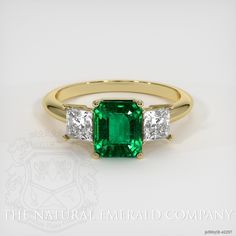 The ring features a beautiful, transparent 1.76 carat emerald shape green emerald with the dimensions of 7.27 x 6.14 x 5.07 mm and a emerald cut. It has a clarity grade of very slightly included (evaluated at eye level), vivid color saturation, and an excellent polish. The origin of this emerald is Zambia. Also featured in the ring: White princess shaped diamonds, weighing approx 0.80 carats, clarity VS1/VS2 and a color grade of E. The ring is entirely set in 18K yellow gold. Gia Certified Emerald Cut Emerald Ring For May Birthstone, Octagon Green Emerald Ring With Center Stone, Gia Certified Princess Cut Emerald Ring, Green Emerald Ring With Princess Cut Center Stone, Green Emerald Princess Cut Ring With Center Stone, Gia Certified Emerald Cut Green Rings, Classic Baguette Cut Green Emerald Ring, Classic Green Baguette Cut Emerald Ring, Gia Certified Asscher Cut Emerald Ring