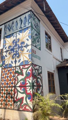 the side of a building painted with colorful tiles