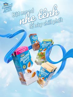 an advertisement for almond milk in the air with blue streamers and clouds behind it